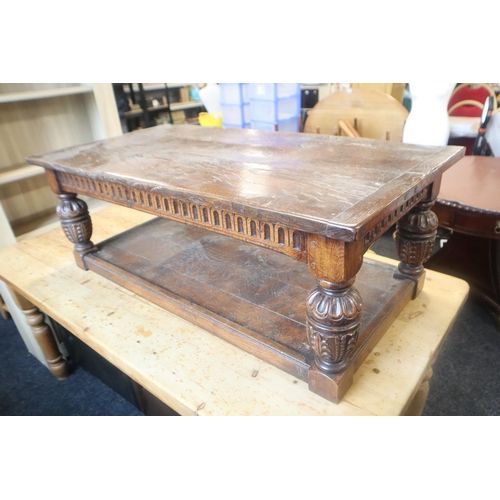 588 - Heavy dark wood coffee table with carved legs and undershelf measures 49