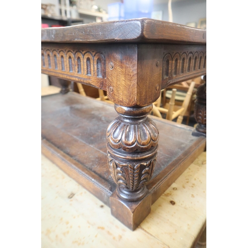 588 - Heavy dark wood coffee table with carved legs and undershelf measures 49