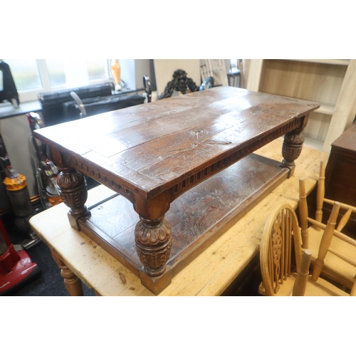 588 - Heavy dark wood coffee table with carved legs and undershelf measures 49