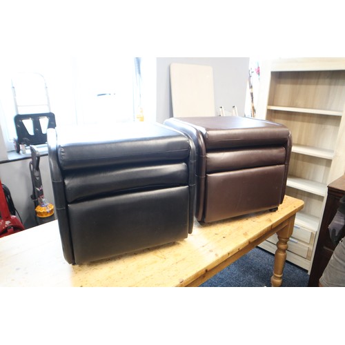 615 - Two arm chairs one brown one black reclining with foot rests, backs fold down to convert to a pouf, ... 