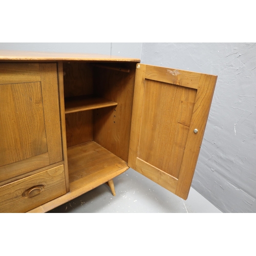 480 - Ercol (Lucian Ercolani) model 366 Windsor elm sideboard, fitted with a double door cupboard, a singl... 