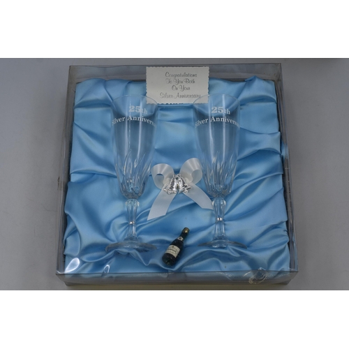 926 - Boxed Pair Of 25th Silver Anniversary Champagne Flutes and Ceramic Anniversary Bell Depicting Weddin... 