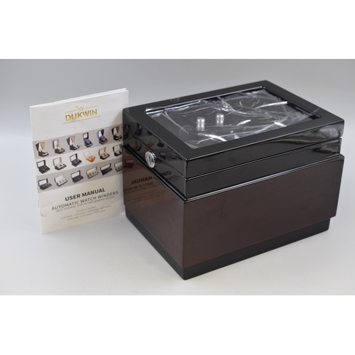 561 - A Dukwin Black and Wood Effect Automatic Watch Winder, Appears New. Powers On When Tested, Power Cab... 