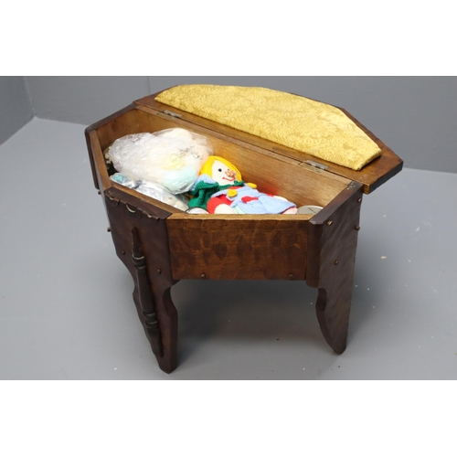 711 - Vintage oak 3 legged sewing box / table with large qty of buttons, knitted bonnets, knitted doll and... 