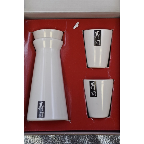 921 - Two Boxed Oriental Dining Kits to include Sake pitcher and Cups, and a Bowls mats and Chopsticks Din... 