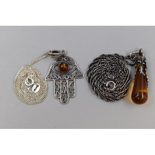 69 - Two Silver Necklace and Pendants includes Amber