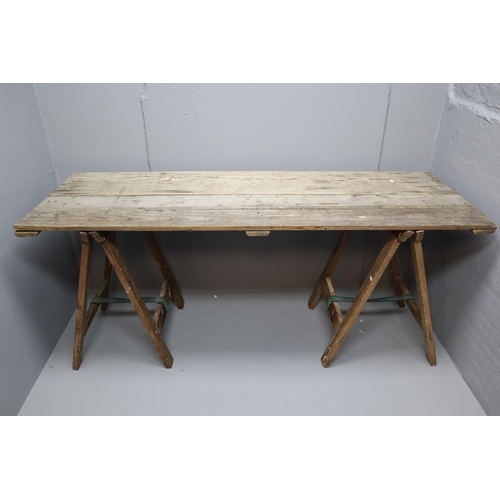 563 - A Vintage Wooden Folding Decorator's Table With Two Trestles. Approx 6ft x 2ft Tabletop.