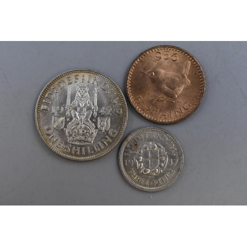 176 - George VI Silver 1942 Shilling, threepence and a 1956 Farthing