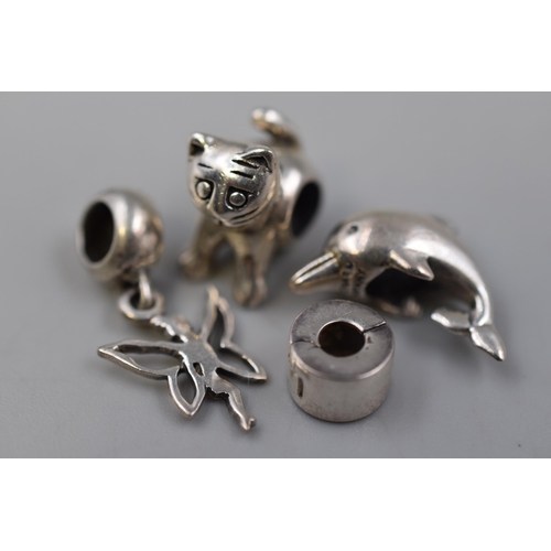 213 - A Selection of Four 925. Silver Charms To Include Dolphin, Cat, Fairy, And Other