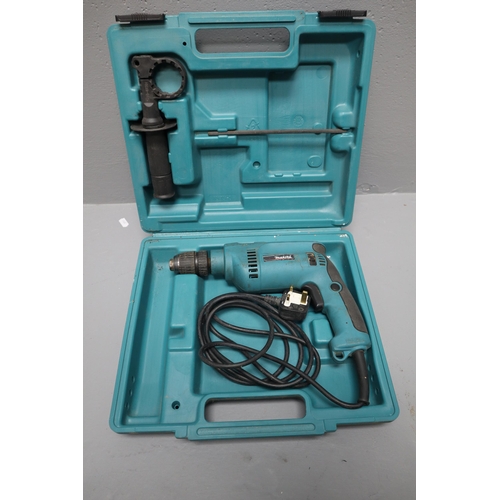 759 - Makita 650 watt corded hammer drill with case working when tested