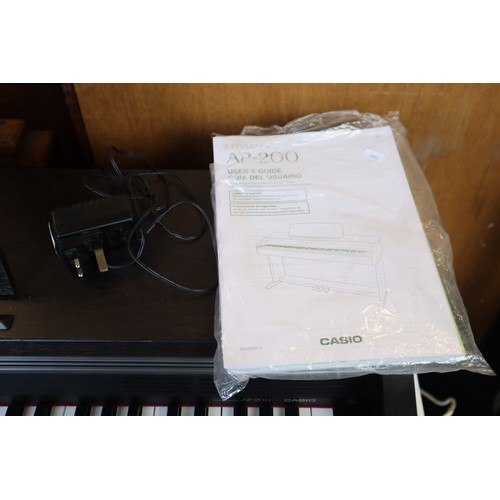 702 - Casio Celviano AP-200 full size electric piano (powers on and works when tested) with manuals