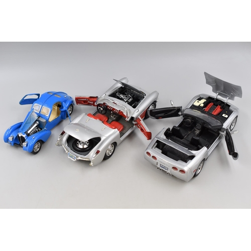 202 - Four Larger Scale (1/24-1/14) Model Cars. Includes Chevrolet Corvette 1957, 2001 Corvette, John Play... 