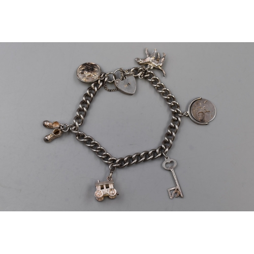 93 - A Silver Padlock Charm Bracelet, With Six Charms (Some Marked Silver)