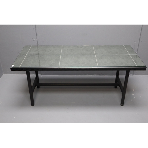 602 - Metal frame tiled coffee table in black and grey with glass top, measures 20