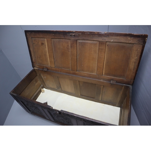 604 - A Large Antique Oak Thirteen Panel Bedding Box On Wooden Castors, With Carved Art Nouveau Front Pane... 