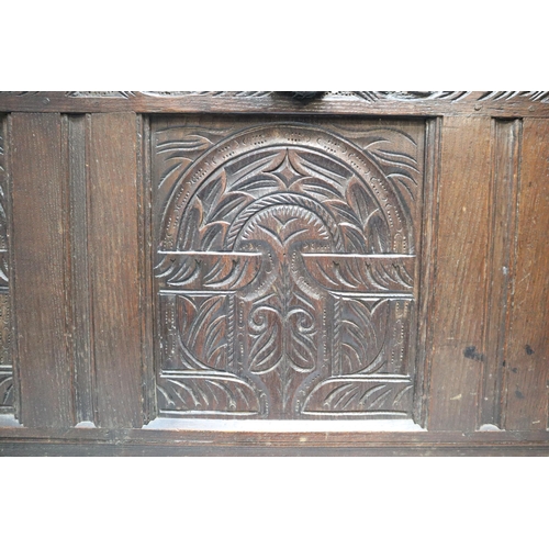 604 - A Large Antique Oak Thirteen Panel Bedding Box On Wooden Castors, With Carved Art Nouveau Front Pane... 