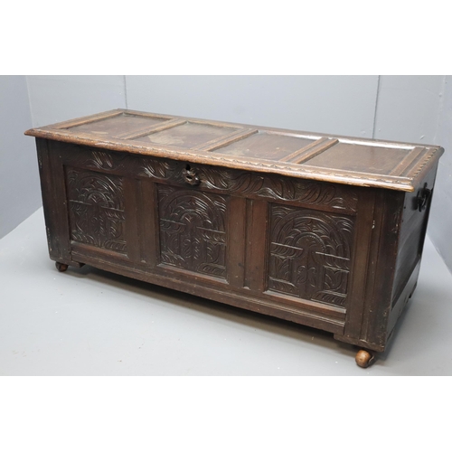 604 - A Large Antique Oak Thirteen Panel Bedding Box On Wooden Castors, With Carved Art Nouveau Front Pane... 