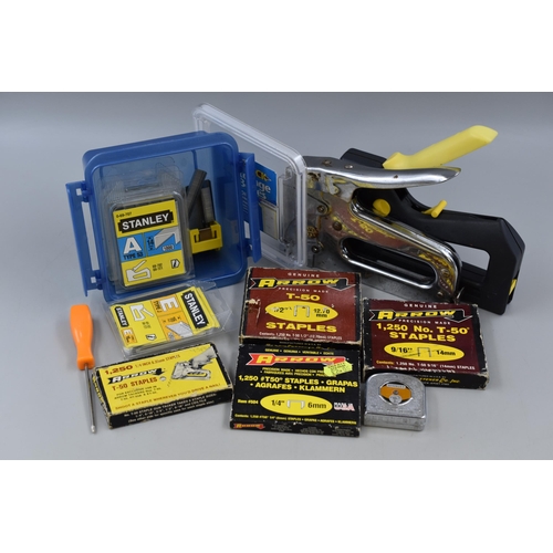 713 - Two heavy duty staple guns with Arrow staples and Stanley staples plus a small tapemeasure