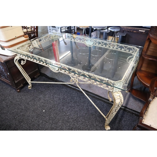 674 - Wrought iron table frame with tempered glass top and four leather dining chairs, one of the chairs h... 