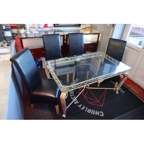 674 - Wrought iron table frame with tempered glass top and four leather dining chairs, one of the chairs h... 