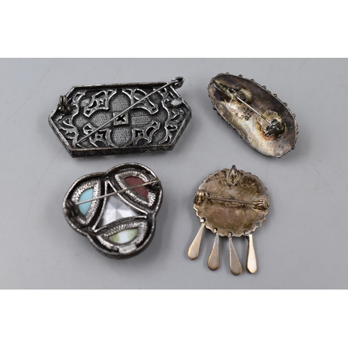 249 - Four Brooches to include Silver and Miracle. One a/f, see images