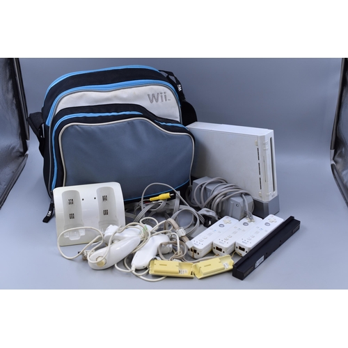 542 - A Nintendo Wii Console With Three Controllers and Various Accessories, In Bag. Powers On When Tested