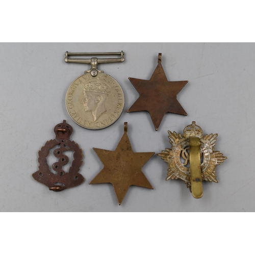 282 - Three WWII Military Medals (Defence Medal and Two 1939-45 Stars), And Two Cap Badges (Royal Army Med... 