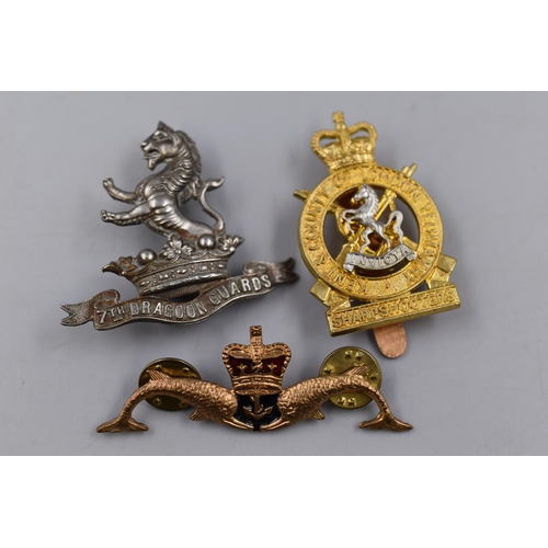 236 - Three Military Badges including Royal Navy Submarine, Kent and County of London Yeomanry and 7th Dra... 