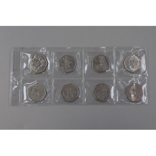 116 - Eight Collectable 50p Coins including Victoria Cross, Peter Rabbit, Sherlock Holmes, Battle of Hasti... 