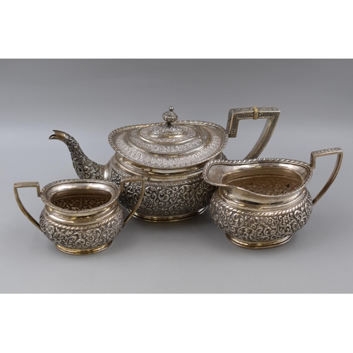 12 - A Three Piece Karachi Embossed Indian Silver Tea Service, By J. Manikrai. Marked T.95