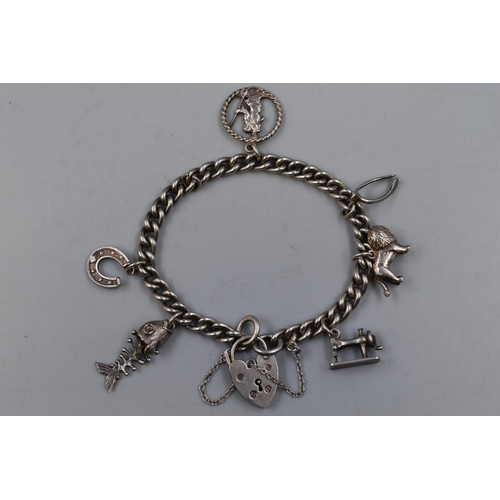 35 - Hallmarked Birmingham Silver Bracelet with Padlock Clasp and 6 Charms