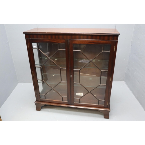 592 - Antique dark wooden display unit with two glass shelves sitting behind two doors with glass (41