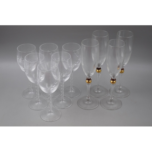 349 - Selection of glasses, six wine glasses with twisted stems and four flutes with gold beaded stems