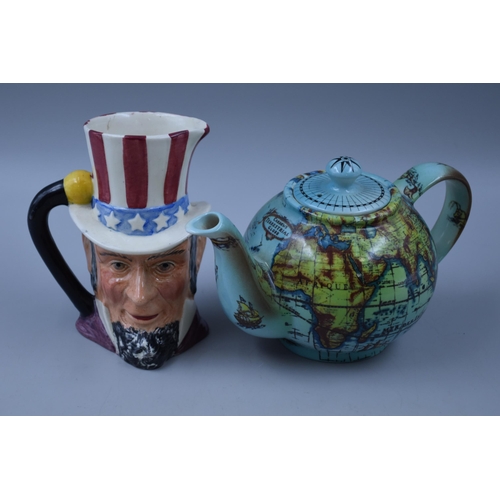 236 - Two small jugs to include Uncle Sam Ridgway pottery and Cardews globe by Cardews design