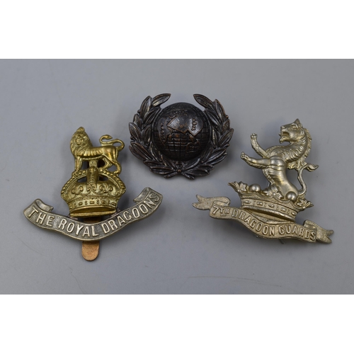 305 - Three Military Badges including 7th Dragoon Guards, The Royal Dragoon Guards and Royal Marines