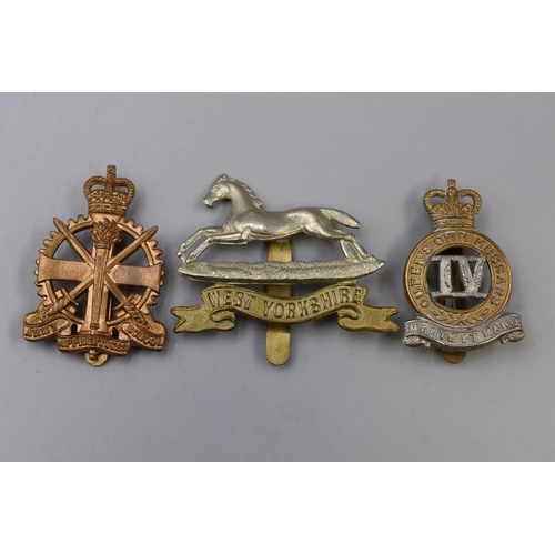 306 - Three Military Badges including West Yorkshire Regiment, Army Apprentice School, and 4th Queens Own ... 