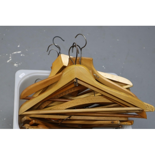 875 - Large selection of wooden coat hangers