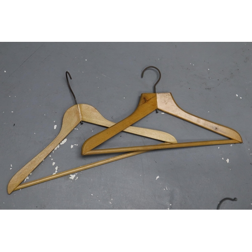 875 - Large selection of wooden coat hangers