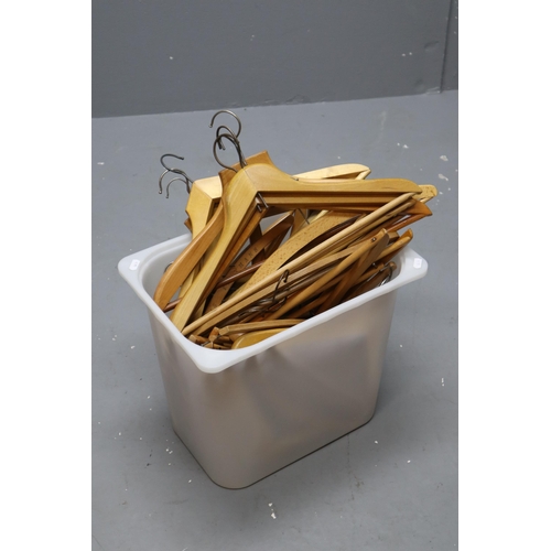 875 - Large selection of wooden coat hangers