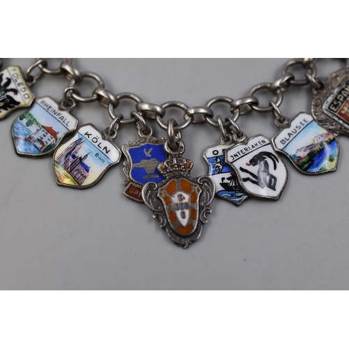 19 - A Silver Enamelled Souvenir Charm Bracelet With 24 Charms of Various Places. Approx 38 Grams