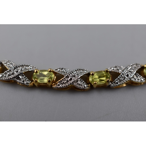 37 - A Gold on 925. Silver Peridot and Clear Stoned Bracelet