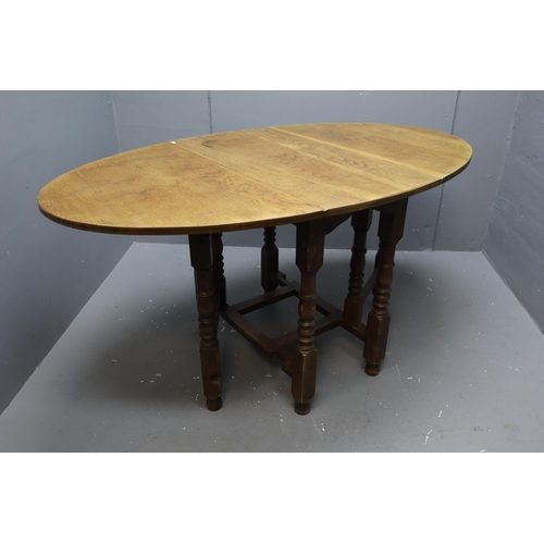 725 - Mid Century Midi Sized Solid Oak Oval Dropleaf Dogleg Table 60