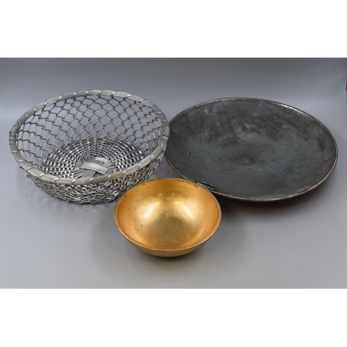 785 - Golden hard plastic charger plates x 8 along with a tray and a bowl with a metal fruit bowl and a co... 