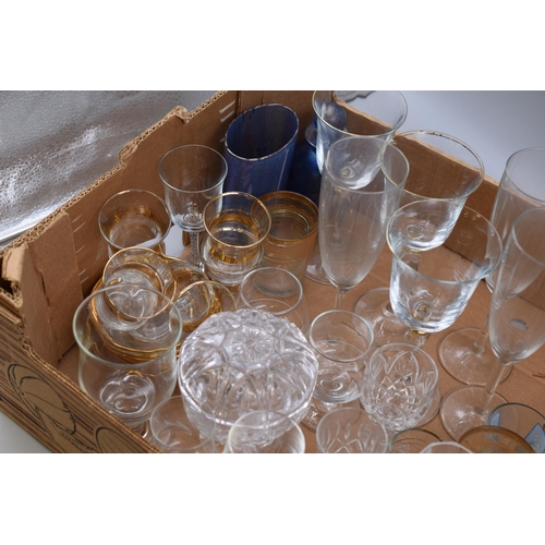 857 - Mixed lot of glassware includes wine glasses, pint glasses, shot glasses, champagne glasses and more