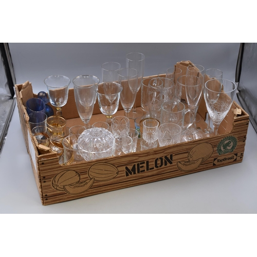 857 - Mixed lot of glassware includes wine glasses, pint glasses, shot glasses, champagne glasses and more