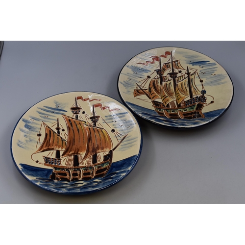 534 - Two high glazed Spanish wall mounting plates depicting galleons at sea (12.5