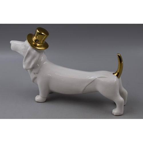 221 - A Ceramic Gold and White Sausage Dog With Tophat and Bowtie, Approx 16cm Tall