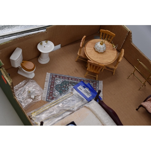 611 - Miniature dolls house furniture to include, round dining table and four chairs, range cooker and kit... 