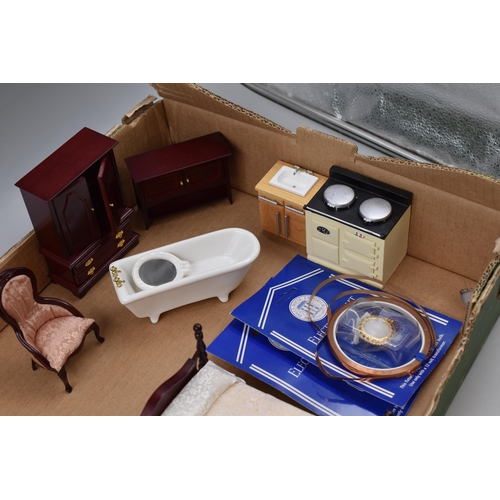 611 - Miniature dolls house furniture to include, round dining table and four chairs, range cooker and kit... 