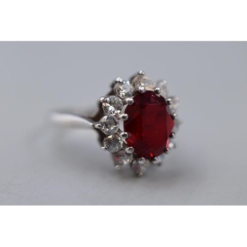 31 - A Hallmarked Dublin Silver Red Stoned Surrounded By Clear Stones Ring, Size Q. Circa 1991